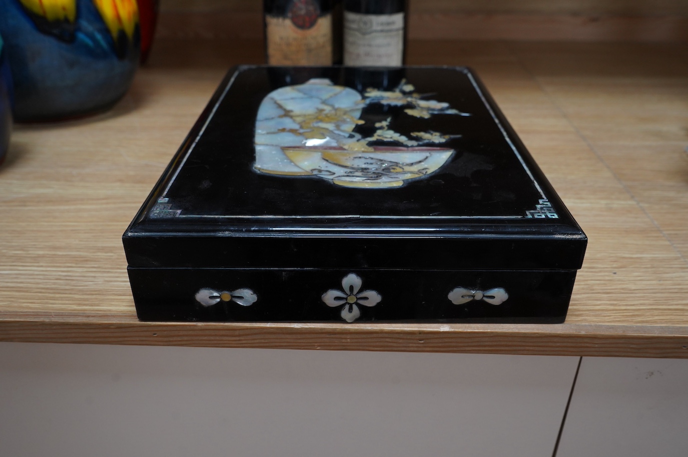 A South East Asian mother of pearl inlaid lacquered box, 36cm. Condition - fair